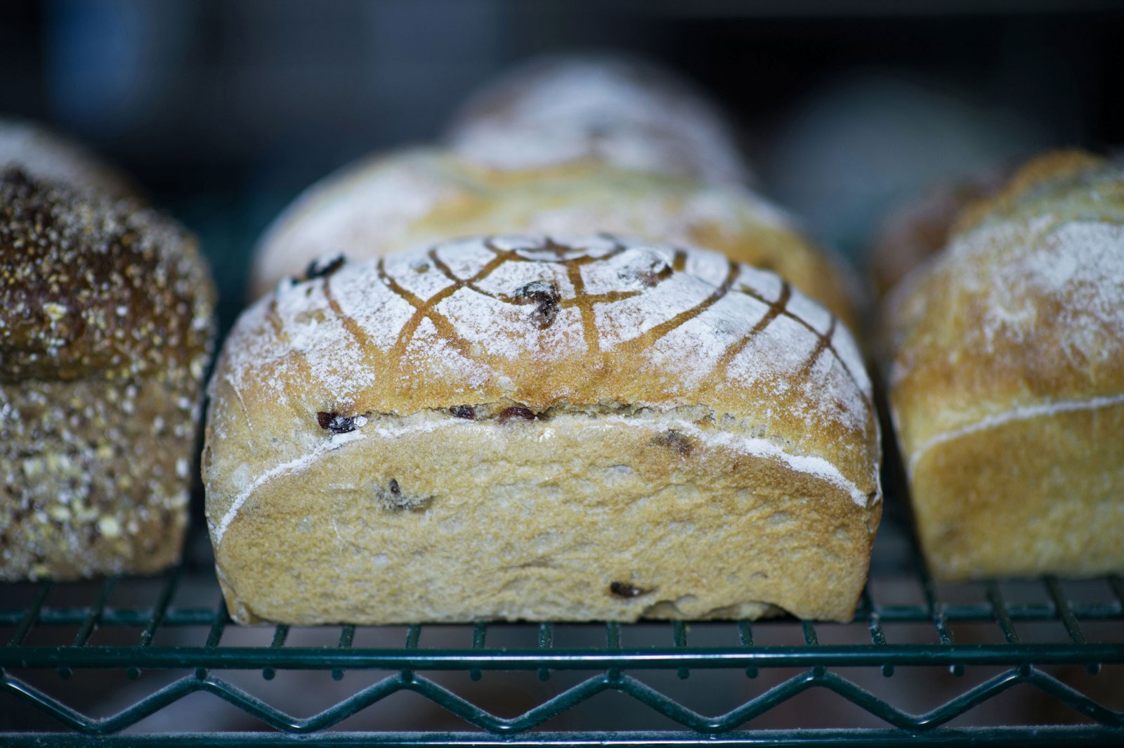 Racks of sourdough loaves and ciabatta cooling at Art Is In Bakery